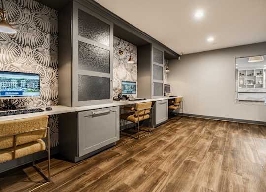 A modern kitchen with wooden floors and a patterned wallpaper at Mallard Bay Apartments, Crown Point, Indiana