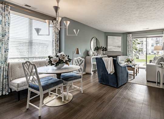 A living room with a white chair set and a blue sofa at Mallard Bay Apartments, Crown Point, Indiana