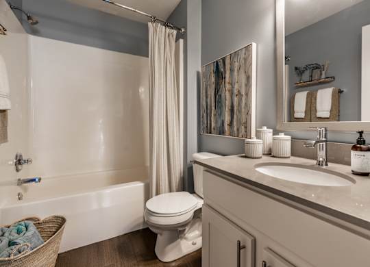A bathroom with a white toilet, sink, and bathtub at Mallard Bay Apartments, Crown Point, Indiana