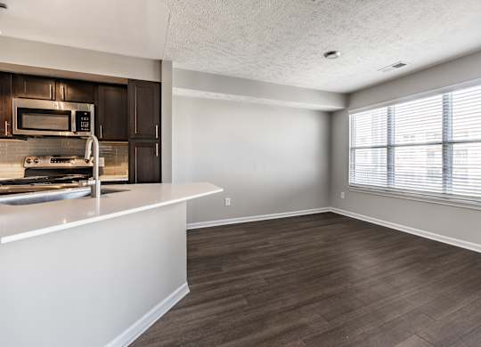 A kitchen with a white countertop and wooden flooring at Mallard Bay Apartments, Crown Point, Indiana