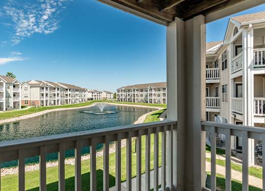 A row of apartment buildings with a body of water in front at Mallard Bay Apartments, Crown Point, Indiana