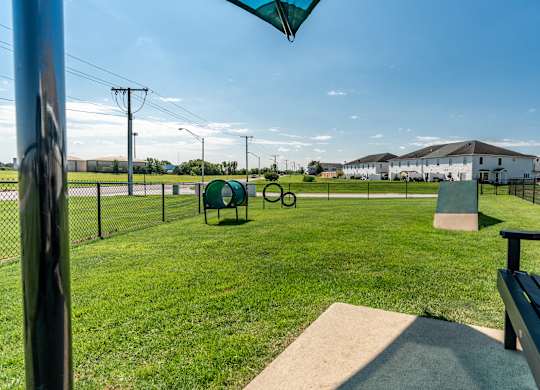 A park with a bench and a fence at Mallard Bay Apartments, Crown Point, Indiana