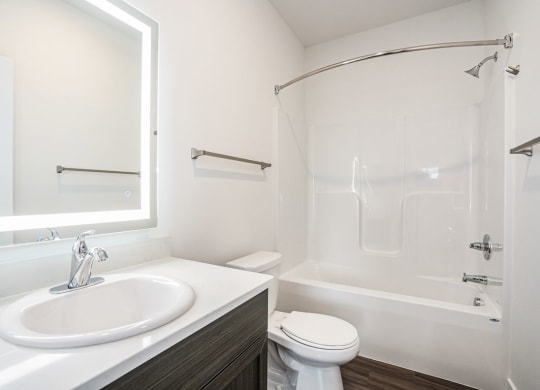 a bathroom with a sink toilet and bathtub at Meadowbrooke Apartment Homes, Grand Rapids, Michigan