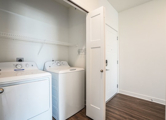 a laundry room with a washer and dryer at Meadowbrooke Apartment Homes, Grand Rapids, Michigan