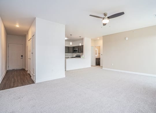 an empty living room with a ceiling fan at Meadowbrooke Apartment Homes, Michigan