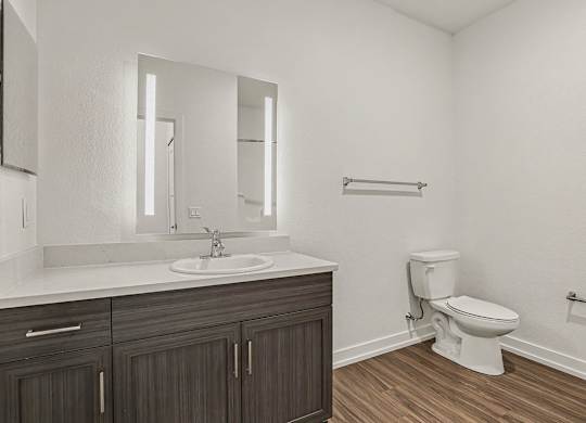 A bathroom with a toilet and sink at Meadowbrooke Apartment Homes in Grand Rapids, MI 49512