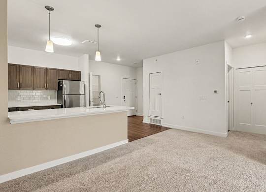 A kitchen and dining room with a breakfast bar at Meadowbrooke Apartment Homes in Grand Rapids, MI 49512
