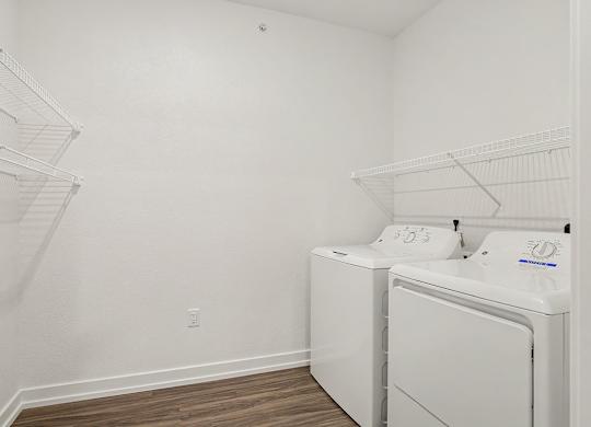 A laundry room with a washer and dryer at Meadowbrooke Apartment Homes in Grand Rapids, MI 49512