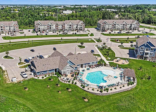 A bird's eye view of a residential area with a swimming pool at Meadowbrooke Apartment Homes in Grand Rapids, MI 49512