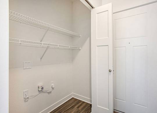 An entry closet with shelves at Meadowbrooke Apartment Homes in Kentwood, MI 49512