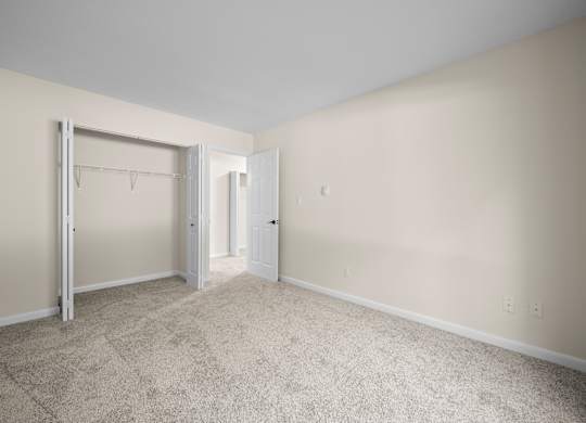 A room with a carpeted floor and two doorsk at Timberlane Apartments, Peoria, Illinois