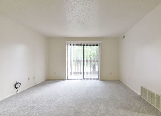 Living Room to Private Balcony at Old Monterey Apartments in Springfield, MO