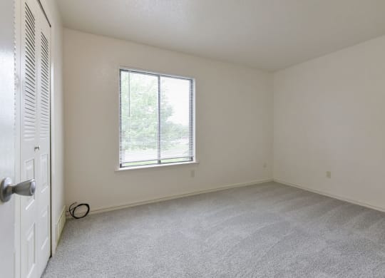 Spacious Bedroom with Large Window at Old Monterey Apartments in Springfield, MO