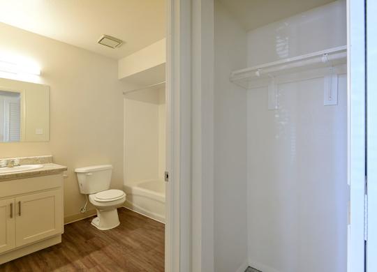 A white bathroom and a linen closet at Old Monterey Apartments in Springfield, MO