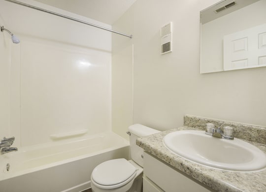 an upgraded bathroom with white cabinets at Newport Village Apartments, Portage, MI