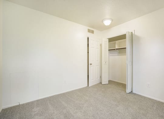 a bedroom with a large closet at Newport Village Apartments, Portage, MI