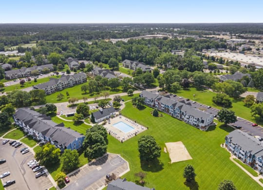 an aerial view of a pool with sundeck at Newport Village Apartments, Portage, MI