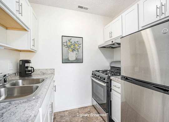 A kitchen with a stainless steel appliances at Newport Village Apartments, Portage, MI
