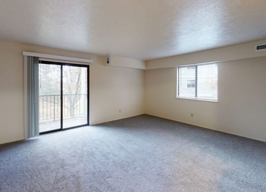 enlarged living room with a sliding glass door to a balcony at North Pointe Apartments, Indiana, 46514