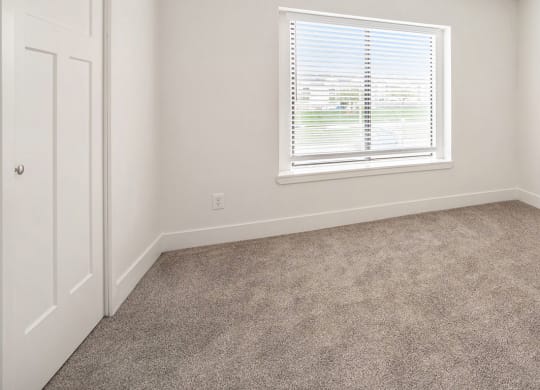Bedroom with carpet and a window at North Pointe Apartments in Elkhart, IN
