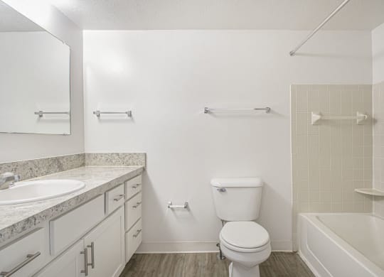 an upgraded bathroom with a sink toilet and a bath tub at North Pointe Apartments in Elkhart, IN