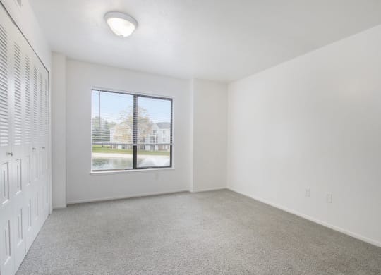 bedroom with a large window and carpet at North Pointe Apartments in Elkhart, IN