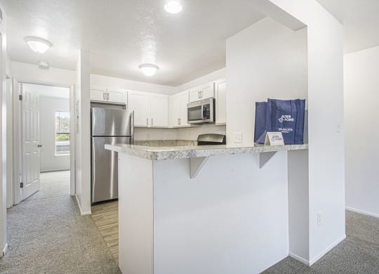 a kitchen with a breakfast bar at North Pointe Apartments in Elkhart, IN