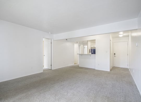 living room and kitchen with carpeting at North Pointe Apartments in Elkhart, IN