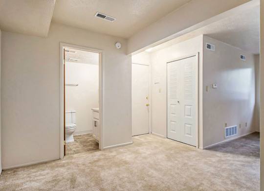 An entryway with a closet and a door to a full bathroom at Normandy Village Apartments, Michigan City