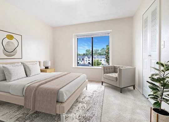 A bedroom with a large bed and a window at North Pointe Apartments, Elkhart