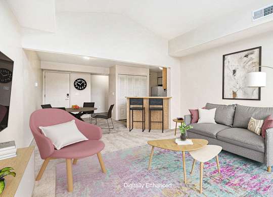 A living room with a grey couch and plush carpeting at North Pointe Apartments, Elkhart