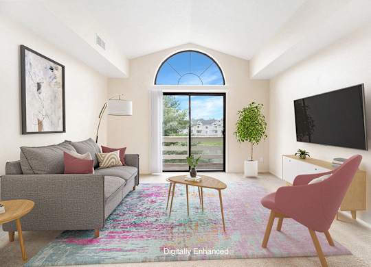 A living room with a cathedral ceiling and a slider to a balcony at North Pointe Apartments, Elkhart