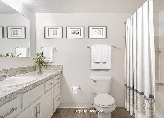 A bathroom with a large vanity and bathtub and shower at North Pointe Apartments, Elkhart