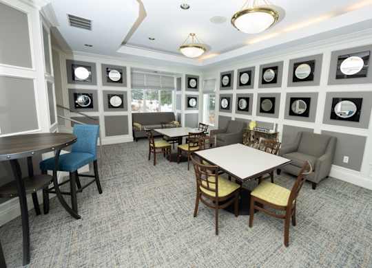 A dining room with a table surrounded by chairs and pictures on the wall  at Northport Apartments, Macomb, MI, 48044