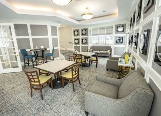 A room with a table and chairs in the middle of the room  at Northport Apartments, Macomb, MI, 48044