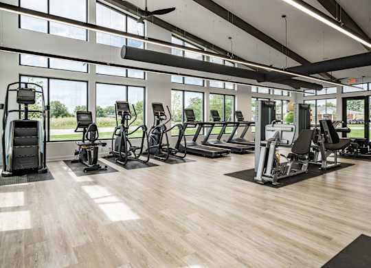 A gym with treadmills, elliptical machines, and other cardio equipment.