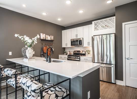 A kitchen with a white countertop and a refrigerator.