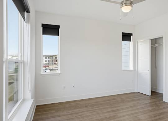 A room with a ceiling fan and a window with blinds at Nuvo Flats, Indiana, 46410