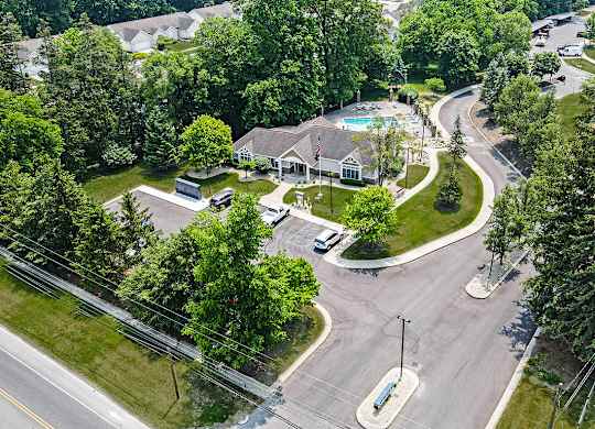 A bird's eye view of a apartment community entrance with a pool and trees at Orchard Lakes Apartments, Toledo, 43615