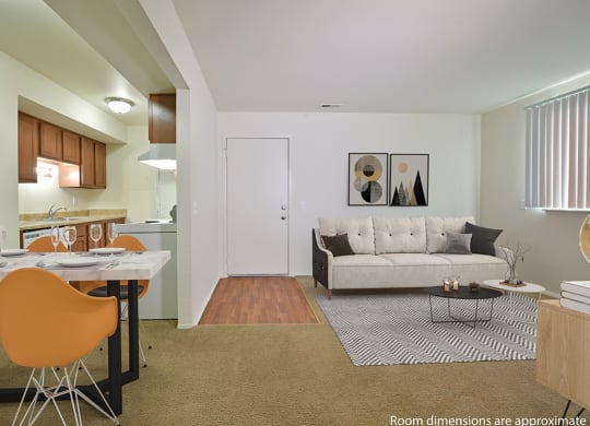 Living Room With Kitchen View at Perry Place Apartments, Grand Blanc, MI