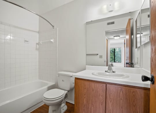 a bathroom with a toilet sink and bathtub at Beacon Hill and Great Oaks Apartments, Illinois, 61109