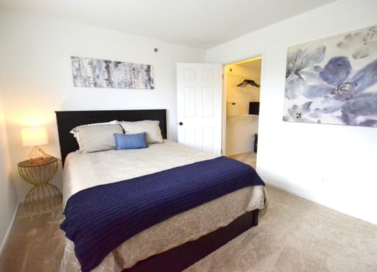 a bedroom with a bed and a nightstand at Northport Apartments, Macomb, MI, 48044