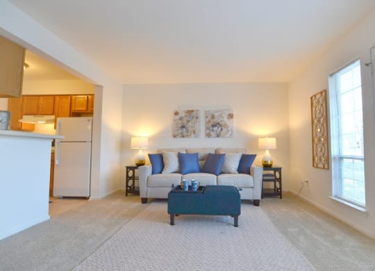 a living room with a couch and a coffee table  at Northport Apartments, Macomb, 48044
