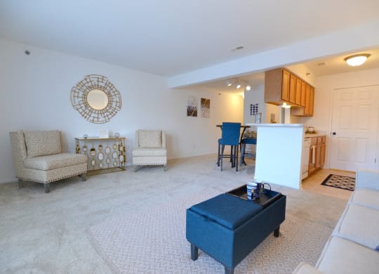 a living room with a couch a chair and a table at Northport Apartments, Macomb, Michigan