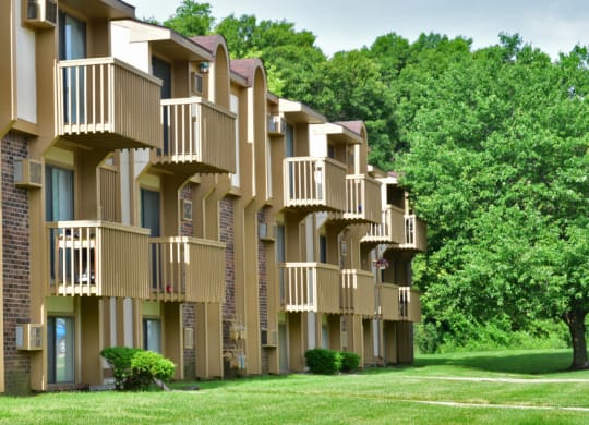 a row of apartment buildings with balconies and trees in the background at Beacon Hill and Great Oaks Apartments, Rockford, IL
