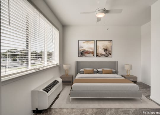 a bedroom with a bed and two windows  at Uptown Square Apartments, Troy, 48083