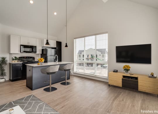 a kitchen and living room with a large window and a view of a house  at Uptown Square Apartments, Troy, MI, 48083