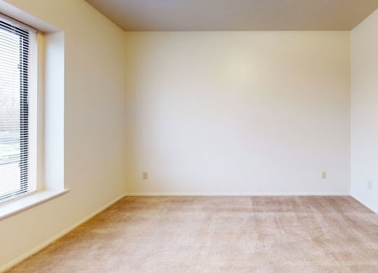 bedroom with a large window and plush carpeting at Pine Knoll Apartments, Battle Creek, 49014