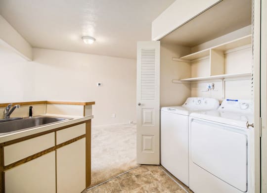 a kitchen with a washer and dryer at Pine Knoll Apartments, Battle Creek, MI