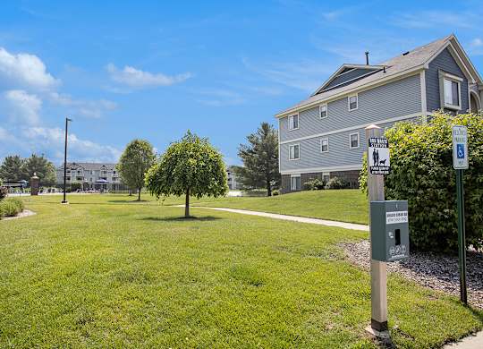 Park-like grounds with pet waste stations at Pine Knoll Apartments, Michigan, 49014